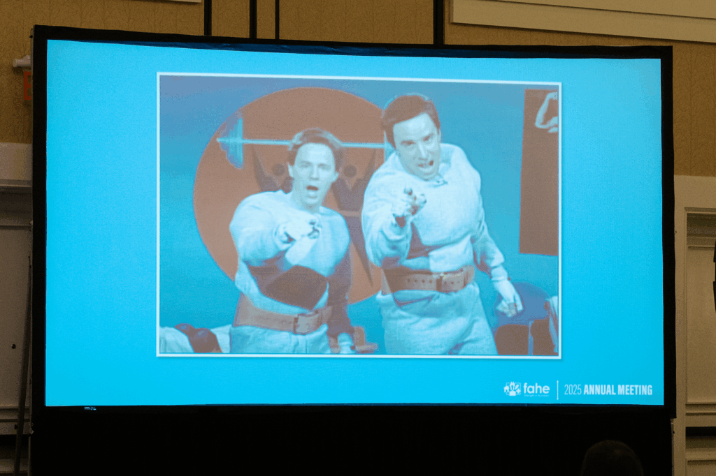 A slide featuring Saturday Night Live’s “Hans and Franz” characters displayed during Fahe’s 2025 Annual Meeting Member Meeting, opening the event with humor and energy as part of Vonda Poynter and Maggie Riden’s kickoff presentation.