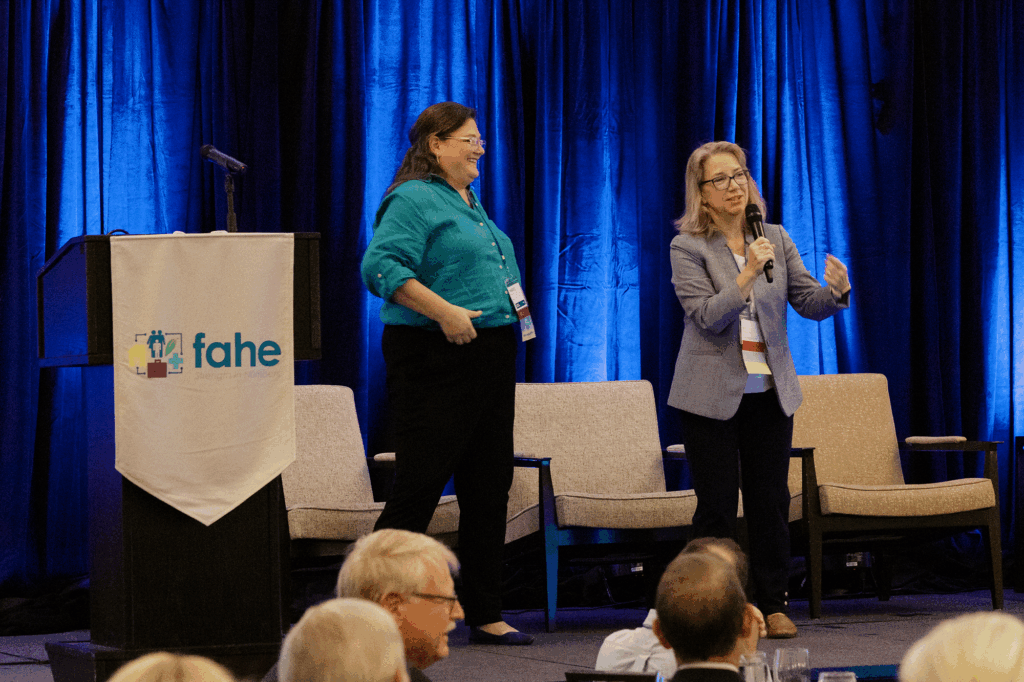 Vonda Poynter and Maggie Riden energize the audience during Fahe’s 2025 Annual Meeting Member Meeting in Kingsport, Tennessee, opening with a lively “Hans and Franz”–themed presentation to motivate Members for the days ahead.