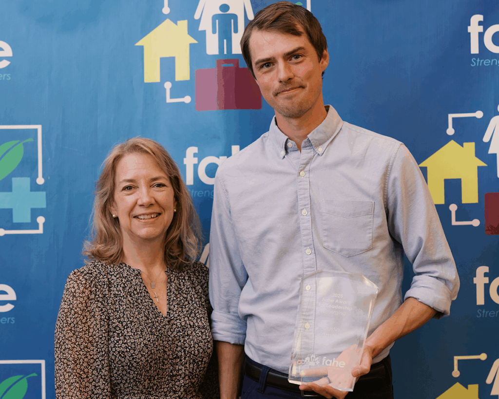 Dustin Smith of Woodlands Development & Lending receives the 2025 Fahe Award for Leadership – Emerging from Vonda Poynter at the Fahe Annual Meeting in Kingsport, Tennessee.