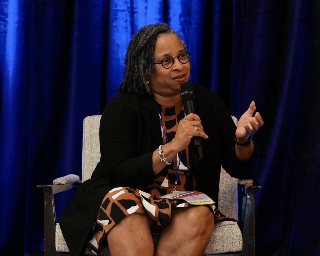 Carol Clarke of Neighborhood Housing Services of Birmingham (NHSB) speaks during Where We Are Today: Caucus Impact, Progress, and Strategies for the Big Challenge at the 2025 Fahe Annual Meeting in Kingsport, Tennessee, highlighting housing successes and community impact.