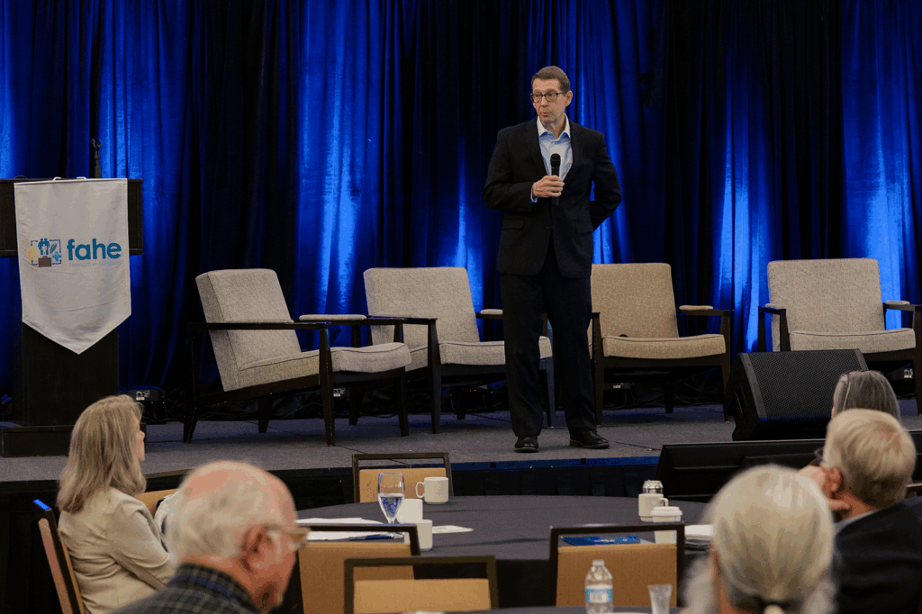 Fahe President and CEO Jim King speaks on stage during the closing session of the 2025 Fahe Annual Meeting in Kingsport, Tennessee, delivering a message on courage, leadership, and the urgent need for action in affordable housing and community development.