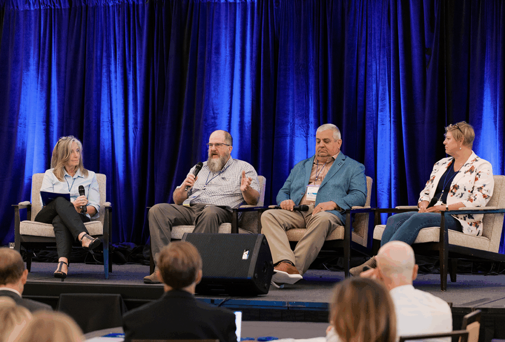 Panel discussion during the Learning in the Aftermath session at the 2025 Fahe Annual Meeting in Kingsport, Tennessee, featuring Pam Johnson of Fahe, Seth Long of HOMES Inc., Randy Welch of SERCAP, and Melisa Winburn of Appalachia Service Project sharing insights on disaster recovery across Appalachia.