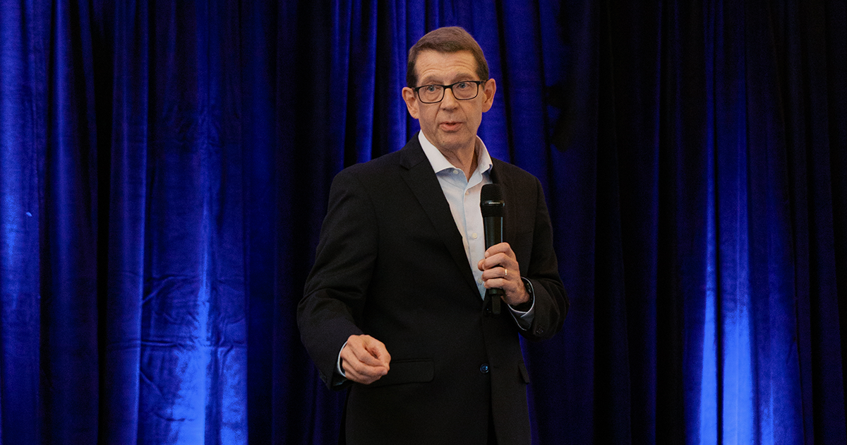 Jim King, CEO of Fahe, speaks on stage during a housing conference, addressing the need for affordable housing solutions across Appalachia.